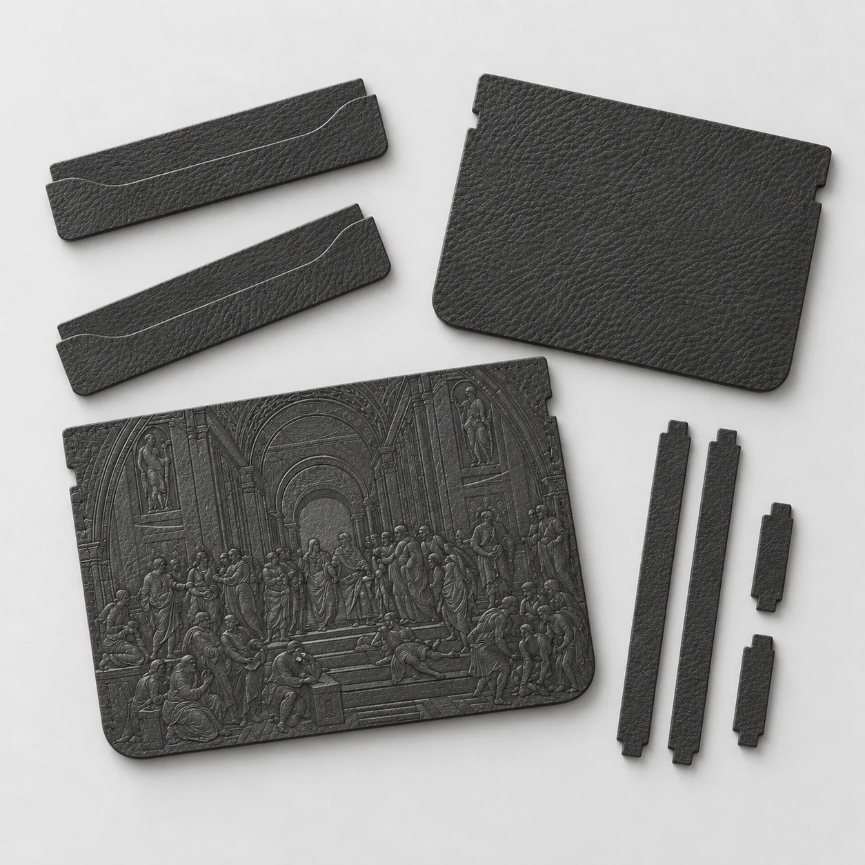 Unstitched charcoal leather cardholder pieces arranged around an embossed Renaissance front panel